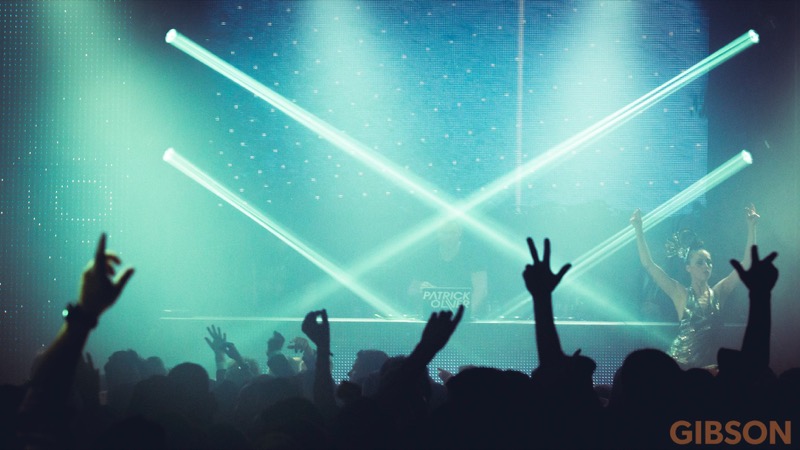 Live performance with stage lighting and crowd